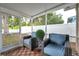 Inviting screened patio features comfortable seating, privacy fencing, and outdoor greenery, creating a relaxing space at 3230 Bellericay Ln, Land O Lakes, FL 34638