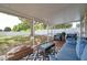 Relaxing screened patio with ample seating, a coffee table, and backyard views, creating a great outdoor living space at 3230 Bellericay Ln, Land O Lakes, FL 34638