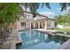 Backyard with a swimming pool, hot tub, patio, grilling area, and mature landscaping at 3404 W Sevilla St, Tampa, FL 33629