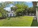 Large, well-maintained backyard with lush green grass and partial view of the pool at 3404 W Sevilla St, Tampa, FL 33629