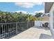 Outdoor balcony with stone tile and a view of trees and a distant pool at 3404 W Sevilla St, Tampa, FL 33629