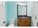 Bathroom featuring a wood vanity, black countertop, and updated fixtures at 3404 W Sevilla St, Tampa, FL 33629