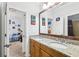 Bathroom with double sinks, granite counters, and a view into an adjacent bedroom at 3404 W Sevilla St, Tampa, FL 33629