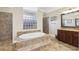Elegant bathroom boasts a soaking tub, glass block window, and tile shower at 3404 W Sevilla St, Tampa, FL 33629