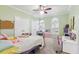Bright bedroom featuring a ceiling fan, two arched windows, and a comfortable bed at 3404 W Sevilla St, Tampa, FL 33629