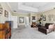 A large carpeted bedroom features tray ceilings and a comfortable chaise lounge for relaxing at 3404 W Sevilla St, Tampa, FL 33629