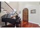 Grand foyer with a beautiful staircase, hardwood floors, and a stunning piano at 3404 W Sevilla St, Tampa, FL 33629