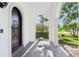 Covered porch with a dark arched front door and sitting area, ideal for welcoming guests at 3404 W Sevilla St, Tampa, FL 33629