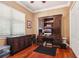 Cozy home office with a large wooden desk, hardwood floors, and a window for natural light at 3404 W Sevilla St, Tampa, FL 33629