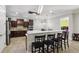 Modern kitchen boasts stainless steel appliances, wooden cabinetry, and a breakfast bar with seating at 3404 W Sevilla St, Tampa, FL 33629