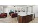 Open concept kitchen with breakfast bar, view to living room and tile floors at 3404 W Sevilla St, Tampa, FL 33629