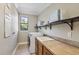 Functional laundry room with a washer, dryer, sink, and ample shelving space at 3404 W Sevilla St, Tampa, FL 33629