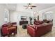 Spacious living room with ceiling fan, tile floor and red leather sofas at 3404 W Sevilla St, Tampa, FL 33629