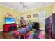 Playroom featuring bright yellow walls, wood floors, and plenty of space for imaginative play at 3404 W Sevilla St, Tampa, FL 33629