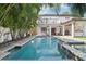 Swimming pool, hot tub, patio, mature landscaping, and a covered porch at 3404 W Sevilla St, Tampa, FL 33629