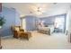 Bright bedroom featuring a ceiling fan, a chair, and a large window at 350 2Nd N St # 1, St Petersburg, FL 33701