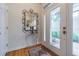 Welcoming foyer area featuring hardwood floors, a decorative mirror, and ample natural light at 350 2Nd N St # 1, St Petersburg, FL 33701