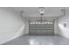 A spacious, clean garage with a freshly painted interior featuring a smooth gray floor and a bright white ceiling and walls at 350 2Nd N St # 1, St Petersburg, FL 33701