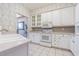 Bright kitchen featuring white cabinetry, tile floors, and modern appliances at 350 2Nd N St # 1, St Petersburg, FL 33701