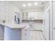 Kitchen features white cabinets and modern appliances, with a breakfast bar and tile floors at 350 2Nd N St # 1, St Petersburg, FL 33701