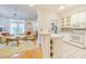 Open concept kitchen with white appliances that connects to a comfortable living space at 350 2Nd N St # 1, St Petersburg, FL 33701