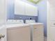 Bright laundry room with white washer and dryer and white cabinets for efficient storage at 350 2Nd N St # 1, St Petersburg, FL 33701