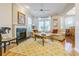 Comfortable living room with fireplace, hardwood floors, and access to a patio area at 350 2Nd N St # 1, St Petersburg, FL 33701