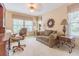 Inviting home office with a comfortable sofa, desk area, and natural light from a window at 350 2Nd N St # 1, St Petersburg, FL 33701