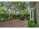 Private brick patio area with seating, mature trees, and lush landscaping at 350 2Nd N St # 1, St Petersburg, FL 33701