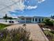 Spacious backyard featuring an outdoor kitchen, gravel area, fire pit, and privacy fence at 3701 Manatee Se Dr, St Petersburg, FL 33705