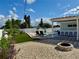 Inviting backyard featuring a pool, fire pit, and outdoor seating under a covered patio at 3701 Manatee Se Dr, St Petersburg, FL 33705