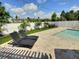 Relaxing backyard lounge area featuring stone pavers, landscaping, and a privacy fence at 3701 Manatee Se Dr, St Petersburg, FL 33705