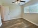 Bedroom featuring a window, wood-look flooring, and a ceiling fan at 3701 Manatee Se Dr, St Petersburg, FL 33705