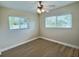 Inviting bedroom featuring wood floors, neutral walls, and natural light through a large window, creating a serene atmosphere at 3701 Manatee Se Dr, St Petersburg, FL 33705