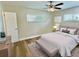 Bedroom featuring a queen bed, ceiling fan, wood-look flooring, and a window at 3701 Manatee Se Dr, St Petersburg, FL 33705