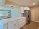 Open kitchen boasts white cabinetry, stainless steel appliances, and a spacious island with a marble countertop at 3701 Manatee Se Dr, St Petersburg, FL 33705