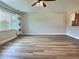 Bright, airy living room with wood-look floors and a large window, offering ample natural light at 3701 Manatee Se Dr, St Petersburg, FL 33705