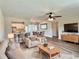Cozy living room with modern furnishings, plush rug, and seamless transition to the kitchen and dining areas at 3701 Manatee Se Dr, St Petersburg, FL 33705