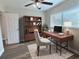 Comfortable home office with wood desk, modern chair, and built-in wood bookcase with natural light from the window at 3701 Manatee Se Dr, St Petersburg, FL 33705