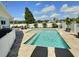Beautiful backyard pool with a tanning ledge, patio, and lush landscaping for backyard enjoyment at 3701 Manatee Se Dr, St Petersburg, FL 33705