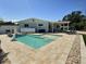 Inviting backyard pool with a tanning ledge, patio, and travertine pavers for outdoor relaxation at 3701 Manatee Se Dr, St Petersburg, FL 33705