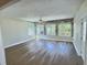 Spacious sunroom featuring stone accents, recessed lights, wood-look flooring, and lots of light at 3701 Manatee Se Dr, St Petersburg, FL 33705