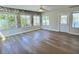 Bright sunroom featuring many windows, stone accent wall, and wood-look flooring at 3701 Manatee Se Dr, St Petersburg, FL 33705