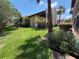 Residential backyard with lush green common area and tropical landscaping at 3814 N Lake Dr # 65, Tampa, FL 33614