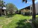 Well maintained backyard with trees in the green common area for residences at 3814 N Lake Dr # 65, Tampa, FL 33614