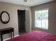 Cozy bedroom with a window view, walk-in closet, and a vanity mirror at 3814 N Lake Dr # 65, Tampa, FL 33614