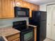 Functional kitchen with maple cabinets, black appliances and efficient layout at 3814 N Lake Dr # 65, Tampa, FL 33614