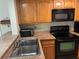 Bright kitchen with granite countertops, stainless steel sink, and modern appliances at 3814 N Lake Dr # 65, Tampa, FL 33614