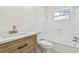 Bathroom featuring a shower and tub combination, white subway tile, and a wooden vanity at 3818 Grove S St, St Petersburg, FL 33705