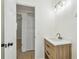 Bathroom featuring a wooden vanity with white countertop, white door and modern lighting at 3818 Grove S St, St Petersburg, FL 33705